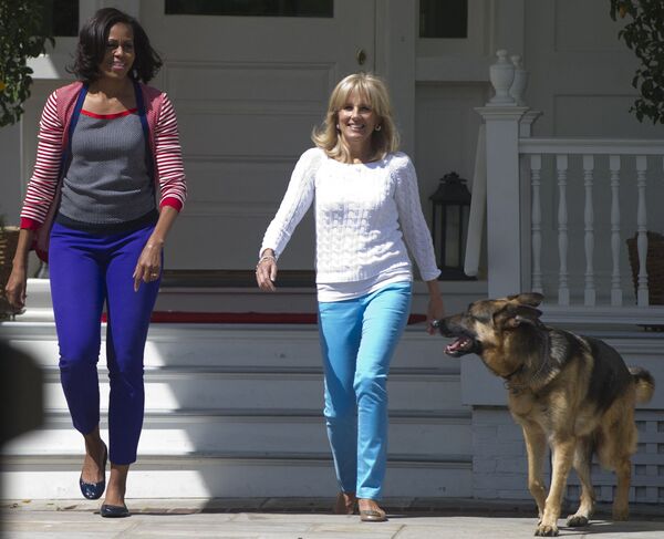 La ex primera dama de Estados Unidos, Michelle Obama, y la esposa del entonces vicepresidente Joe Biden, Jill, con su perro pastor alemán Champ, 2012.   - Sputnik Mundo