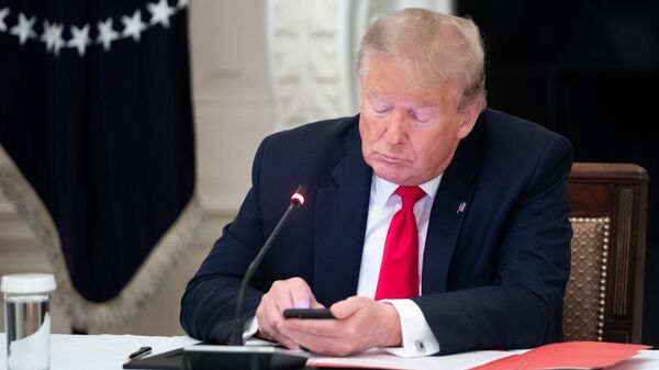 Donald Trump, presidente de EEUU, con su teléfono móvil  - Sputnik Mundo