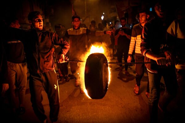 Los palestinos queman neumáticos durante la concentración en Gaza en defensa de uno de los principales lugares sagrados del Islam, la mezquita de al Aqsa en Jerusalén. - Sputnik Mundo