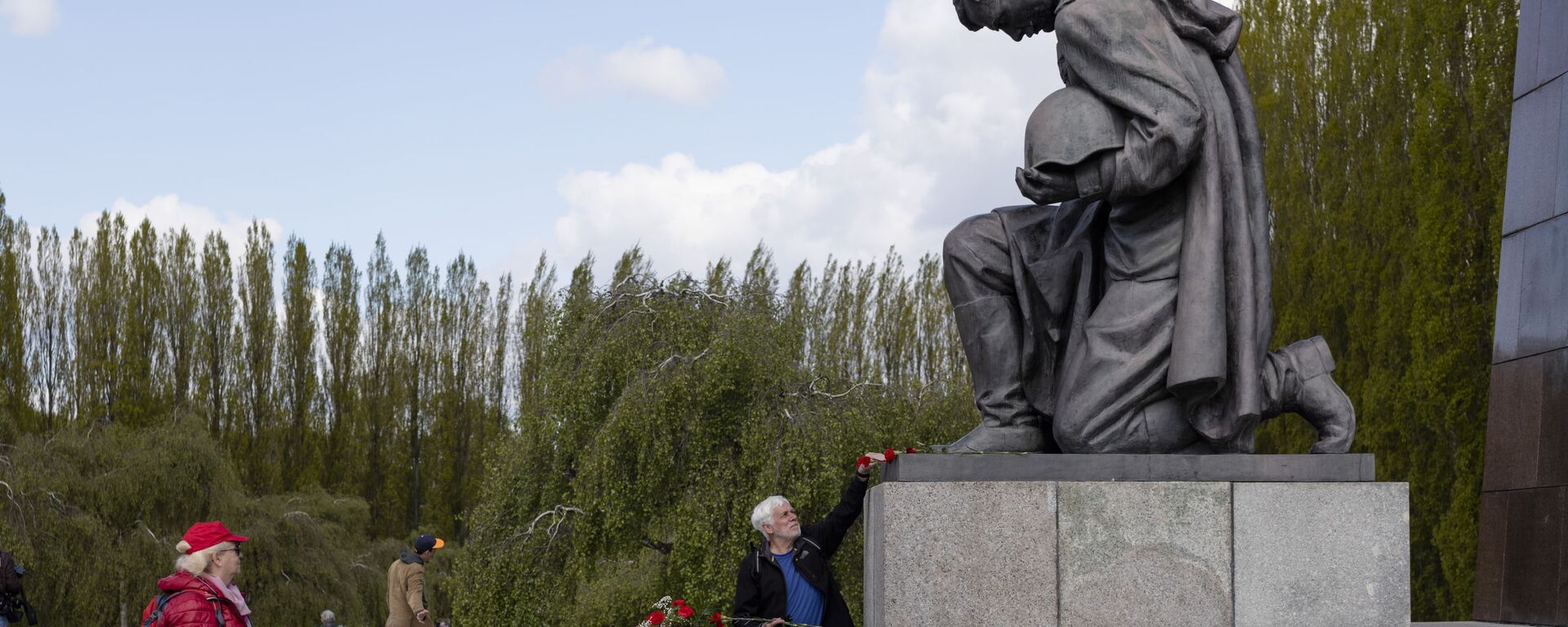 Мужчина возлагает цветы к памятнику советскому солдату на военном мемориале в Трептов-парке в Берлине в ознаменование 76-й годовщины окончания Второй мировой войны - Sputnik Mundo, 1920, 08.05.2021