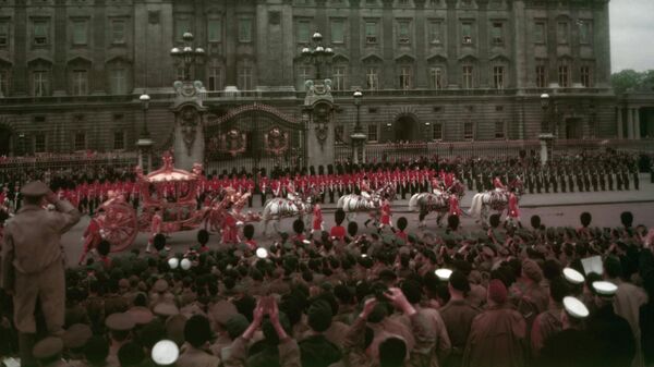 El carruaje de la reina Isabel II pasa por el Palacio de Buckingham al comienzo del viaje procesional a la Abadía de Westminster para la ceremonia de coronación el 2 de junio de 1953 - Sputnik Mundo