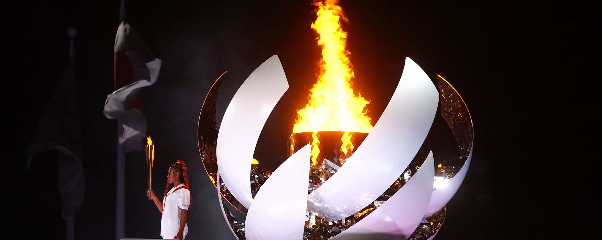 Наоми Осака из Японии держит олимпийский факел после зажжения олимпийского котла на церемонии открытия  - Sputnik Mundo, 1920, 24.07.2021