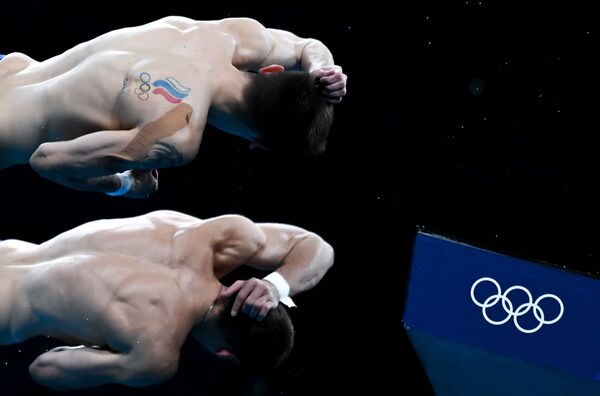 Los atletas rusos Aleksandr Bondar y Viktor Minibaev, durante la competencia en clavados sincronizados desde una plataforma de 10 m de altura. - Sputnik Mundo