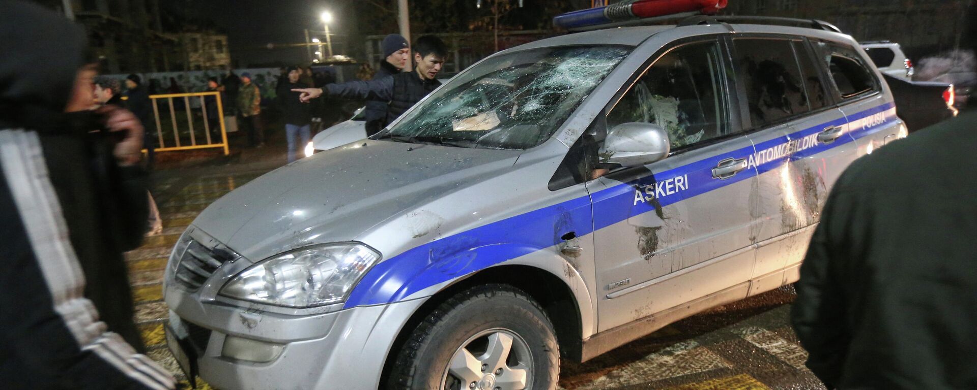Los manifestantes rodean un coche de Policía dañado durante una protesta contra el aumento del costo del gas licuado, en Almaty, Kazajistán, el 4 de enero de 2022 - Sputnik Mundo, 1920, 10.01.2022
