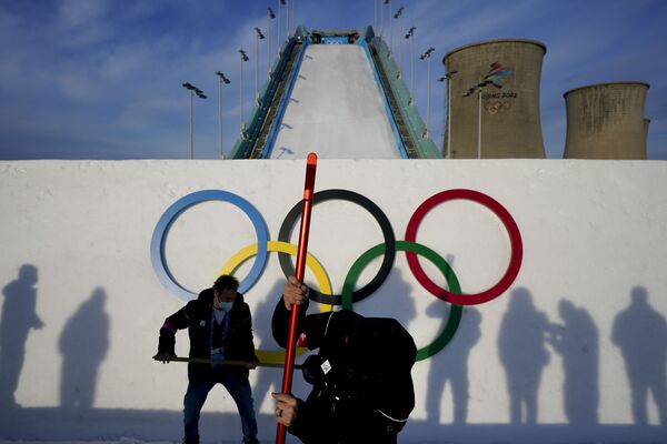 Varios trabajadores inspeccionan el salto de esquí antes del entrenamiento de big air en el Parque de Nieve de Shougang, en Pekín. - Sputnik Mundo