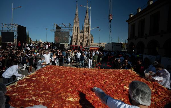Unos cocineros preparan una milanesa gigante durante el festival nacional de este plato en Luján, Argentina. - Sputnik Mundo