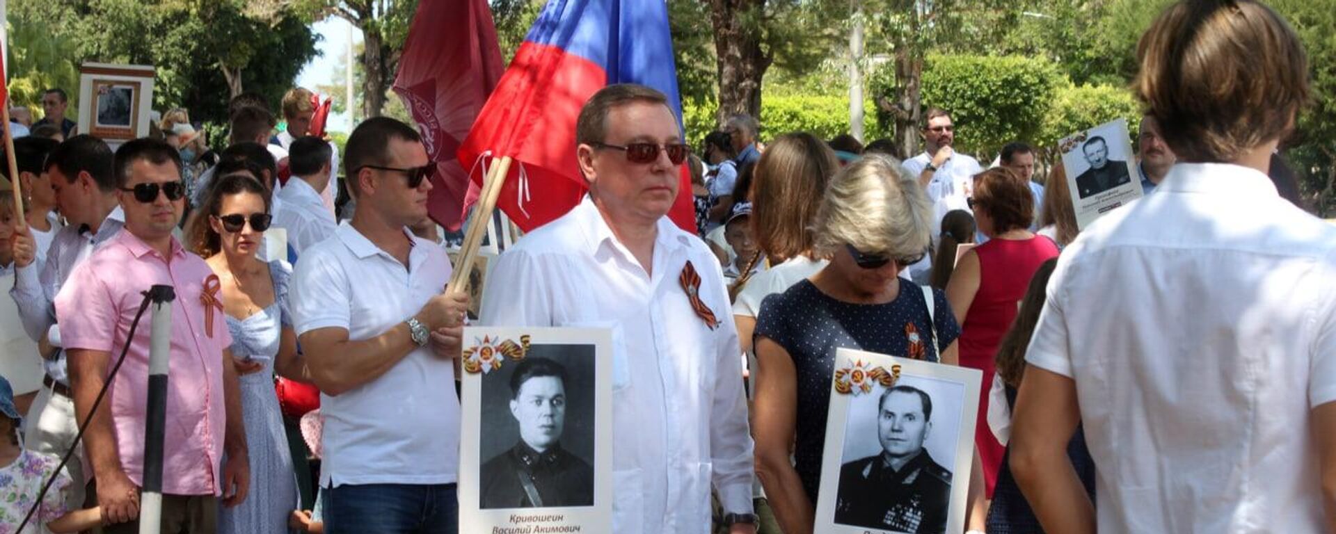 El embajador de Rusia en Cuba, Andrei Guskov (centro) con la foto de su abuelo en el desfile del Regimiento Inmortal desfila en La Habana, Cuba - Sputnik Mundo, 1920, 09.05.2022