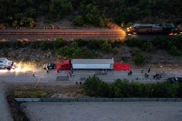 Agentes de la Policía frente a un remolque en el que se encontraron los cuerpos de más de 50 migrantes muertos, en San Antonio, EEUU. - Sputnik Mundo