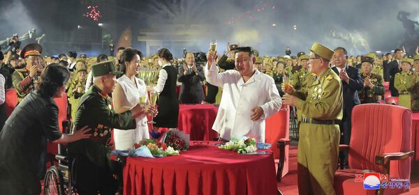 El líder norcoreano Kim Jong-un y su esposa Ri Sol Ju durante la ceremonia por el 90 aniversario de la victoria en la Guerra de Corea, en Pyongyang. 28 de julio del 2022. - Sputnik Mundo