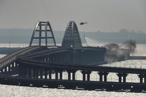 Helicópteros extinguen el incendio de un tren cisterna provocado por la explosión de un vehículo de carga en el puente de Crimea, Rusia. - Sputnik Mundo