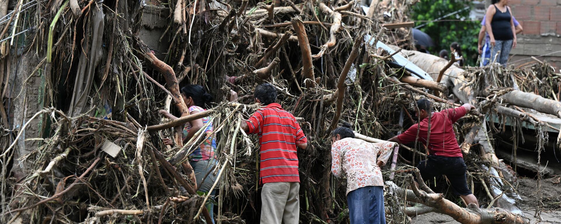 Жители ищут своих пропавших родственников в развалинах дома, разрушенного оползнем во время проливных дождей в Лас-Техериасе, штат Арагуа, Венесуэла - Sputnik Mundo, 1920, 11.10.2022