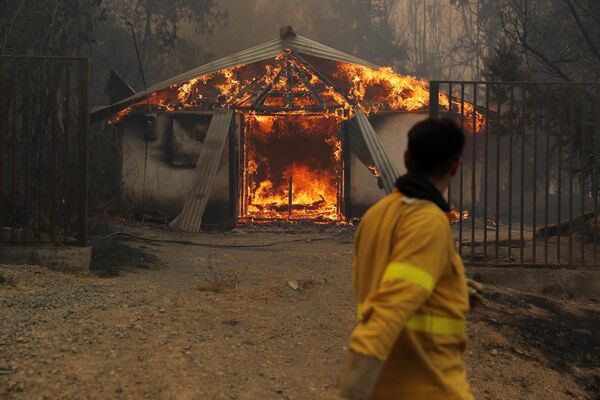 Al menos 24 personas murieron a causa de los incendios forestales que devastan Chile.En la foto: una casa en llamas en Santa Juana. - Sputnik Mundo