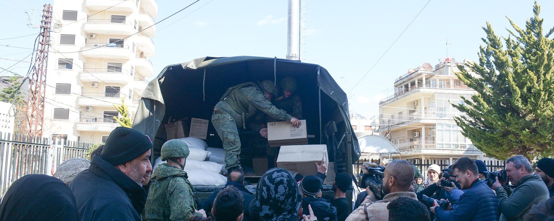 En la base aérea rusa de Hmeymim, en Siria, empezaron a distribuir ayuda humanitaria a las víctimas tras los devastadores terremotos, el 13 de febrero de 2023 - Sputnik Mundo, 1920, 19.07.2023