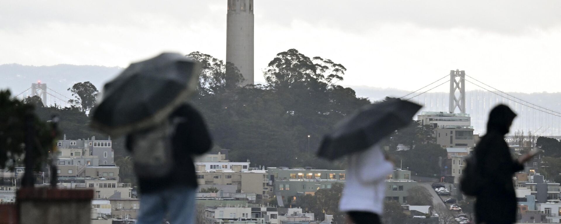 Los peatones llevan paraguas a través de la fuerte lluvia cerca de la calle Lombard en San Francisco, California, el 4 de enero 2023 - Sputnik Mundo, 1920, 19.04.2023