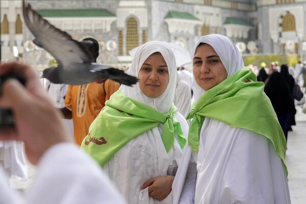Unas participantes del hach procedentes de Irán se fotografían ante la Gran Mezquita de La Meca, Arabia Saudita. - Sputnik Mundo