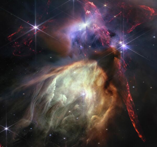 La NASA celebró el primer año de funcionamiento del telescopio espacial James Webb publicando una imagen del nacimiento de una nueva estrella. La imagen muestra la nube molecular Rho Serpens, situada a 390 años luz de la Tierra, y unas 50 estrellas jóvenes. - Sputnik Mundo