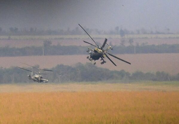 En esta imagen se ve un helicóptero de reconocimiento y ataque Ka-52 Alligator escoltado por un helicóptero polivalente Mi-8 que transporta un equipo de apoyo de fuego y rescate. - Sputnik Mundo