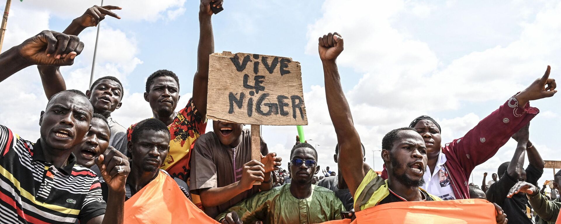 Partidarios del Consejo Nacional para la Salvaguarda de la Patria (CNSP) de Níger agitan una pancarta mientras se manifiestan en Niamey el 27 de agosto de 2023  - Sputnik Mundo, 1920, 20.09.2023