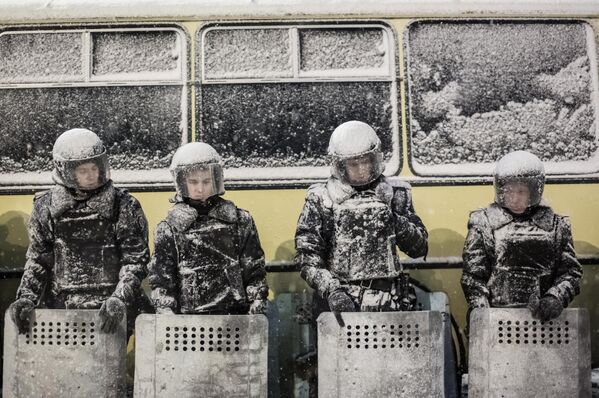 Las fuerzas del orden, a su vez, desplegaron en Kiev unidades especiales procedentes de toda Ucrania.En la foto: agentes de la Policía en un cordón en la Plaza de la Independencia de Kiev. - Sputnik Mundo