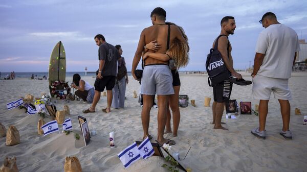 Amigos de los muertos durante el ataque de Hamás del 7 de octubre al Festival de Música Nova en el sur de Israel organizaron una vigilia en memoria de las víctimas en la playa de Tel Aviv, Israel, el sábado 11 de noviembre de 2023.
 - Sputnik Mundo