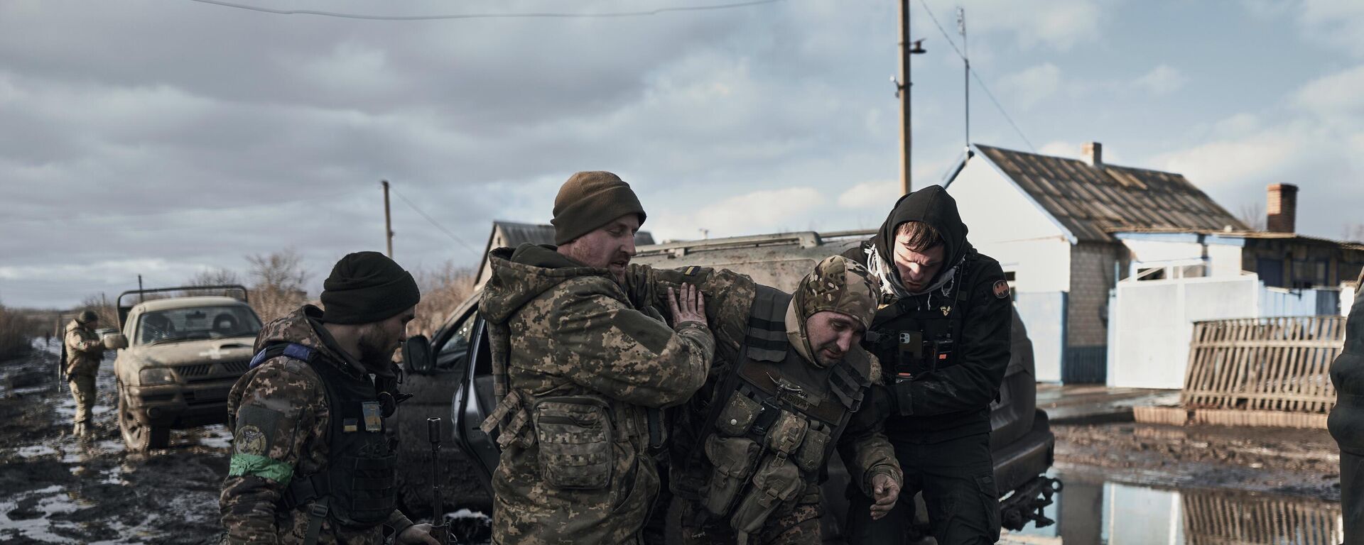 Soldados ucranianos ayudan a un compañero herido a subir a un vehículo de evacuación en la línea del frente en la región de Donetsk, el 20 de febrero de 2023  - Sputnik Mundo, 1920, 12.04.2024