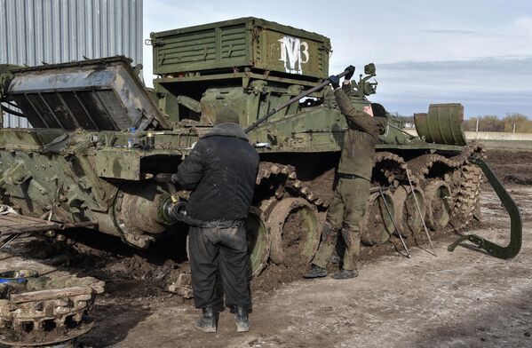 Soldados realizan labores de mantenimiento para devolver un tanque al servicio. - Sputnik Mundo