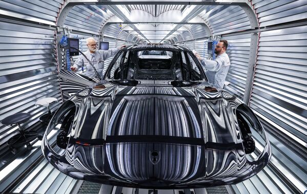 Trabajadores montando un automóvil Porsche Macan en la línea de producción y control de calidad de la fábrica de Porsche en Leipzig, Alemania. - Sputnik Mundo