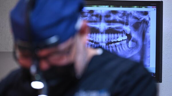 Un dentista atiende a un paciente (archivo) - Sputnik Mundo