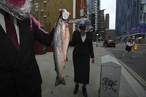 Miembros de Ocean Rebellion, organización internacional que lucha contra el impacto humano en los mares, sosteniendo peces en Londres para protestar contra la cruel pesca del atún.  - Sputnik Mundo