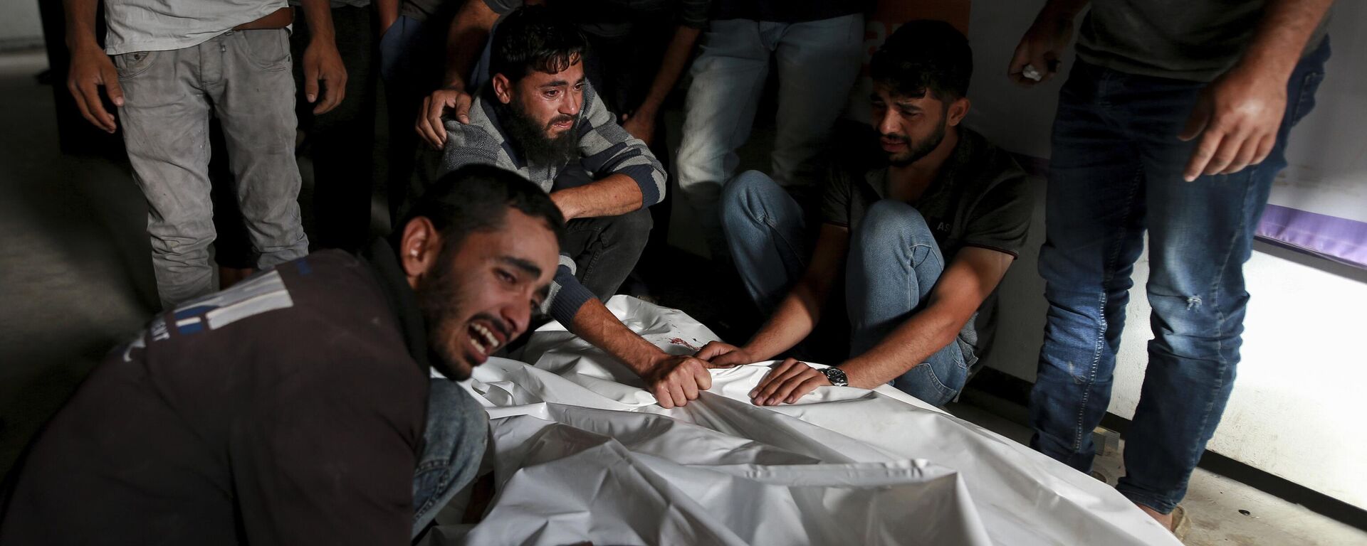 Palestinos lloran sobre los cuerpos de familiares muertos en un ataque aéreo israelí, en una morgue en Rafah, Franja de Gaza, el 27 de mayo de 2024. - Sputnik Mundo, 1920, 29.05.2024