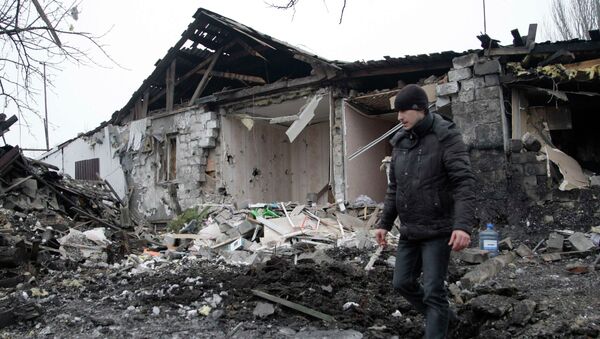 A man walks near a residential building, which according to locals was recently damaged by shelling, in Donetsk, eastern Ukraine January 19, 2015. - Sputnik Mundo