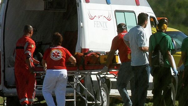A person rescued from the Cidade de Sao Mateus, a floating oil production, storage and offloading ship (FPSO), is wheeled to an ambulance by paramedics at the Eurico de Aguiar Salles airport in Vitoria - Sputnik Mundo
