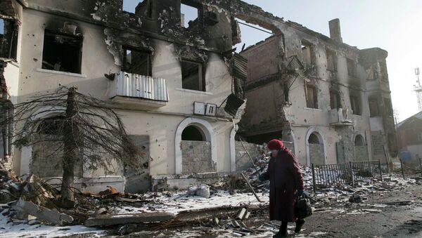 A woman walks past a damaged building in the town of Vuhlehirsk near Donetsk, Ukraine, February 14, 2015. - Sputnik Mundo