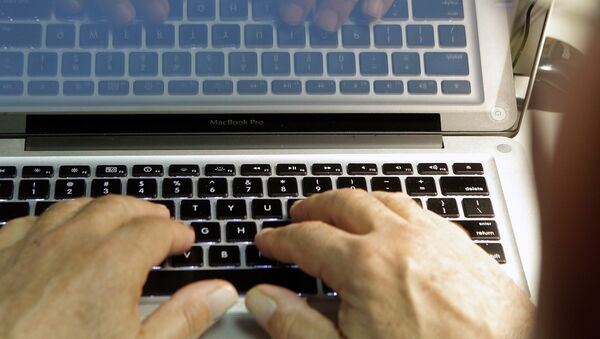 This photo illustration shows hands typing on a computer keyboard on Wednesday Feb. 27,2013 - Sputnik Mundo