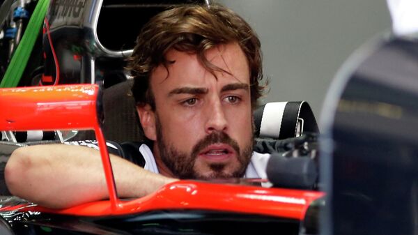 Formula One - F1 - Malaysian Grand Prix 2015 - Sepang International Circuit, Kuala Lumpur, Malaysia - 26/3/15 McLaren's Fernando Alonso sits in his car in the team garage - Sputnik Mundo