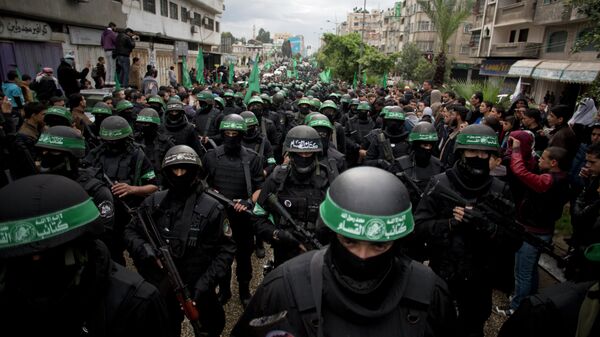 Hombres armados palestinos muestran sus habilidades militares durante una manifestación para conmemorar el 27º aniversario del grupo militante Hamas, en la ciudad de Gaza, el domingo 14 de diciembre de 2014. - Sputnik Mundo