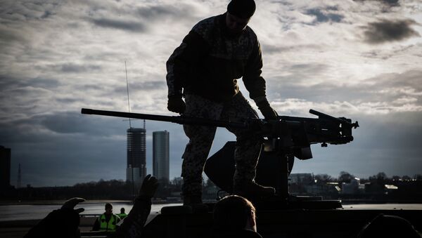Latvian soldier atop his Humvee at a static display in Riga, Latvia. - Sputnik Mundo