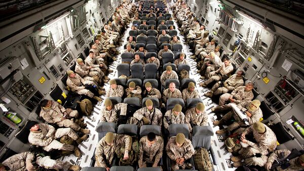 Marines and sailors sit aboard an Air Force C-17 transport aircraft on the flight line here, before departing for Camp Dwyer, Afghanistan, Oct. 30 - Sputnik Mundo