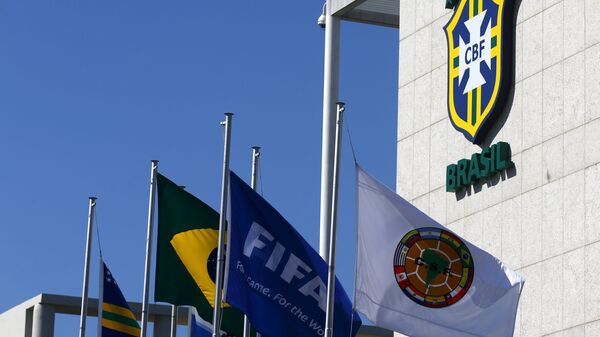 Flags of FIFA (2nd R) and Conmebol (R) are pictured outside the Brazilian Football Confederation (CBF) headquarters - Sputnik Mundo