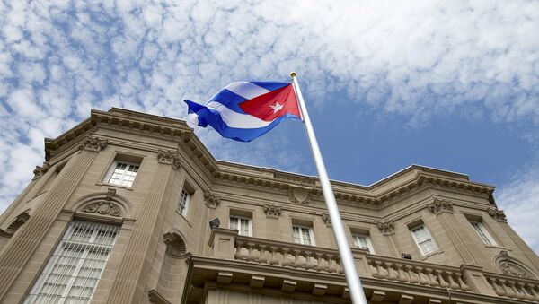 The Cuban national flag is seen raised over their new embassy in Washington, July 20, 2015. - Sputnik Mundo