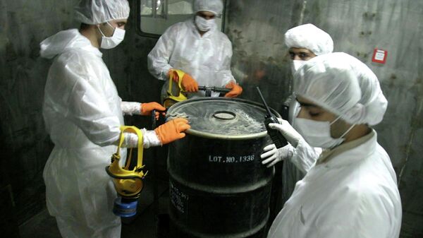 Iranian technicians lift a barrel of yellow cake to feed it into the processing line of Uranium Conversion Facility (UCF) in Isfahan, Iran in an August 8, 2005 file photo. - Sputnik Mundo