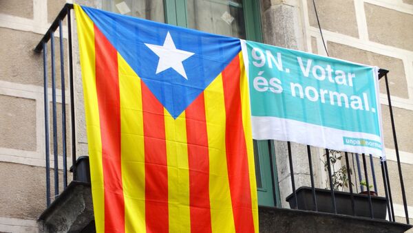 Bandera independentista catalana y bandera que dice 9 de noviembre. Votar es normal - Sputnik Mundo