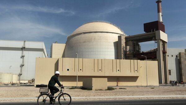 In this Oct. 26, 2010 file photo, a worker rides a bicycle in front of the reactor building of the Bushehr nuclear power plant, just outside the southern city of Bushehr. - Sputnik Mundo