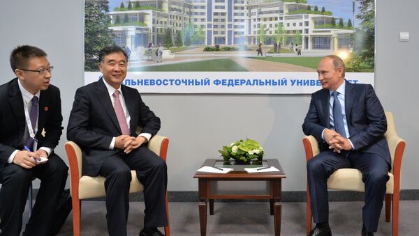 Presidente de Rusia, Vladímir Putin (dcha.), durante su encuentro con el vice primer ministro de China, Wang Yang, en el marco del Foro Económico Oriental - Sputnik Mundo