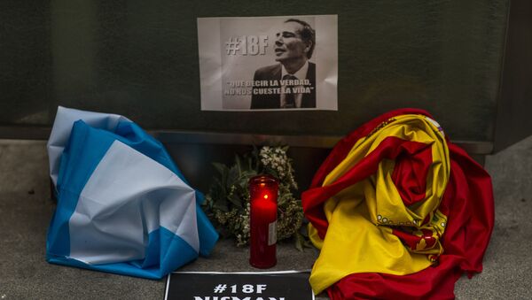 The Argentinean and Spanish flag, a candle, flowers and banners reading telling the truth should not cost one's life are placed in front of the Argentinean Embassy as people gather for justice and against impunity in the case of the mysterious death of late prosecutor Alberto Nisman, in Madrid, Spain, Wednesday, Feb. 18, 2015. - Sputnik Mundo
