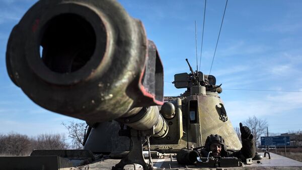 A Ukrainian soldier smiles riding on a self-propelled artillery piece near Artemivsk, eastern Ukraine, Monday, Feb. 23, 2015 - Sputnik Mundo