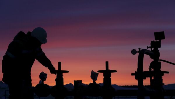 A worker checks the valve of an oil pipe at an oil field owned by Bashneft company near the village of Nikolo-Berezovka, northwest from Ufa, Bashkortostan, Russia, in this January 28, 2015 file photo. - Sputnik Mundo