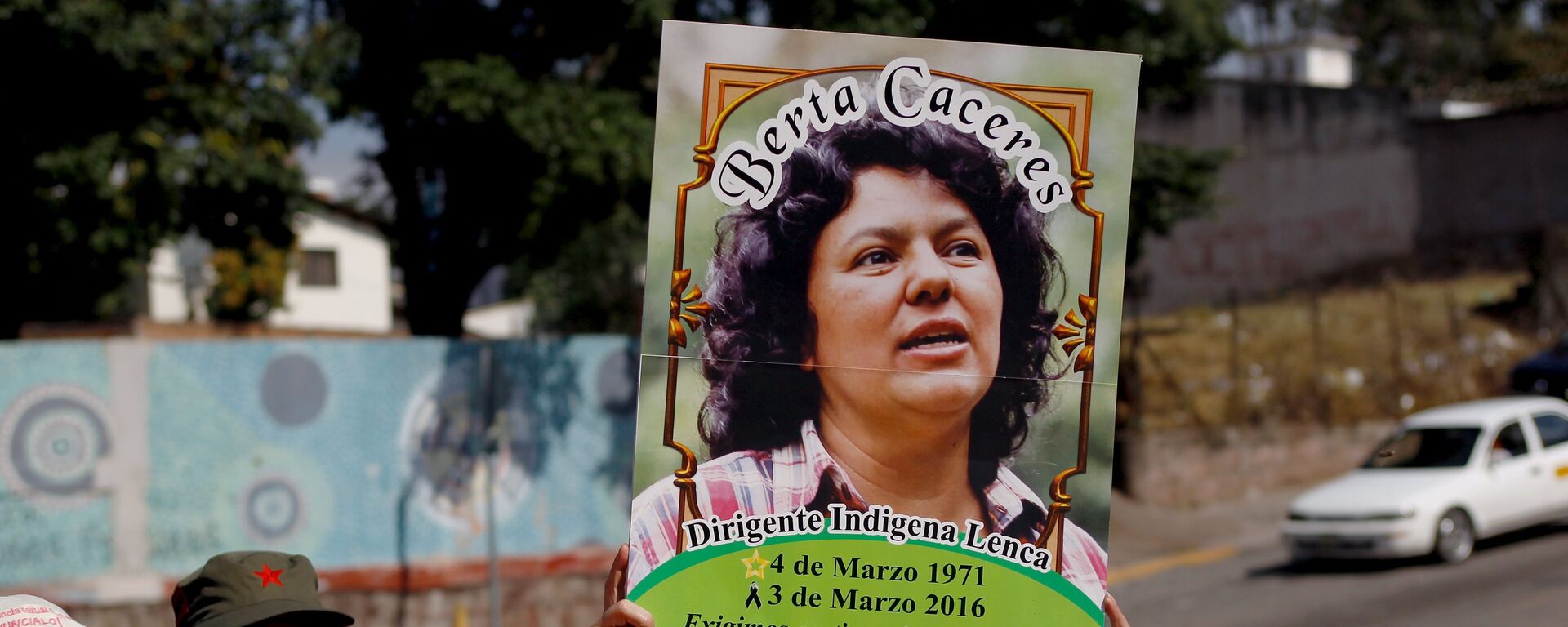 An activist holds up a photo of slain environmental rights activist Berta Caceres during a protest to mark International Women's Day outside the presidential house in Tegucigalpa - Sputnik Mundo, 1920, 22.04.2021