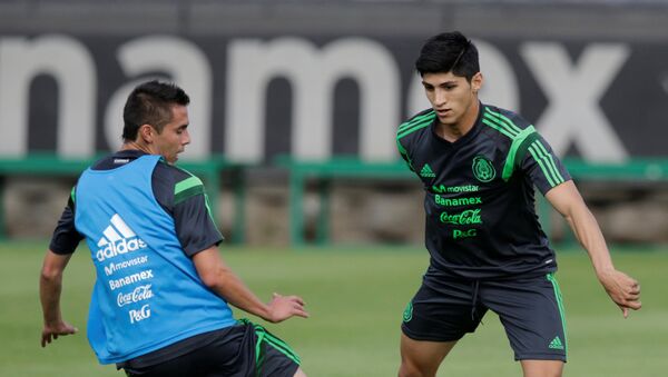 Mexico striker Pulido dribbles the ball past Aguilar during a practice session in Mexico City - Sputnik Mundo