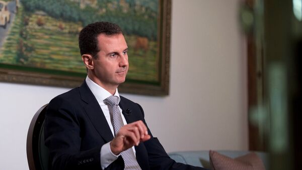 Syria's President Bashar al-Assad speaks during an interview with a Cuban news agency - Sputnik Mundo
